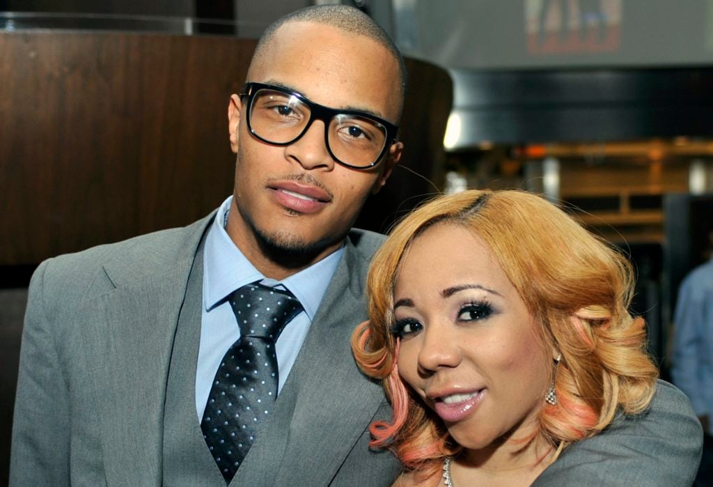 FILE - In this Oct. 3, 2010 file photo, Grammy award winning artist Clifford "TI" Harris, left, poses for media with his wife Tameka "Tiny" Harris, right, during an Alzheimers "For the Love of Our Fathers" foundation honoree luncheon at the Luckie Lounge in Atlanta. Police got unexpected help talking a suicidal man down from an Atlanta skyscraper when rapper T.I. showed up. Officer James Polite says the hip-hop star joined the crowd outside the 22-story building Wednesday and told officers he wanted to help. Police said the man agreed to come down in exchange for a few minutes face-to-face with T.I., whose real name is Clifford Harris. (AP Photo/Gregory Smith, File)