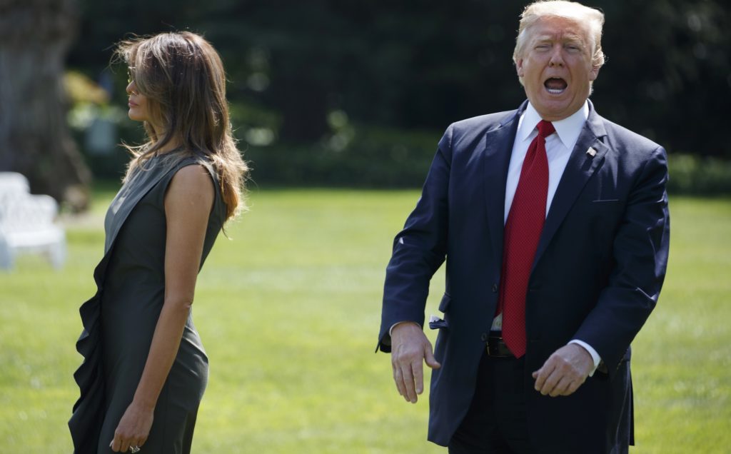 President Donald Trump shouts to reporters as he walks with first lady Melania Trump to board Marine One on the South Lawn of the White House, Friday, Sept. 8, 2017, in Washington. (AP Photo/Evan Vucci)