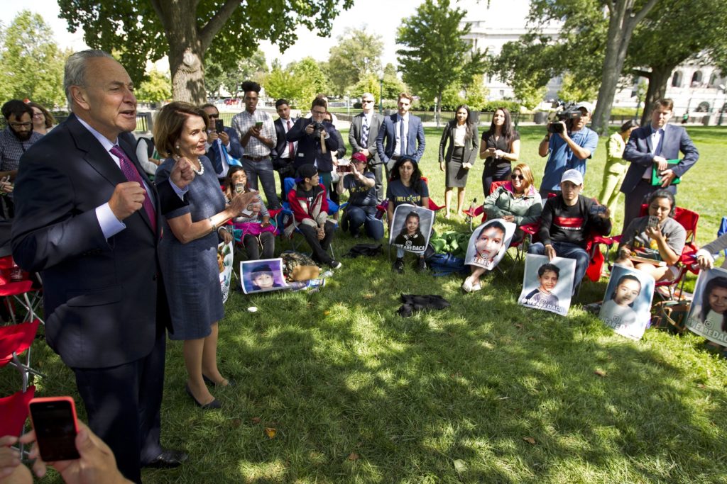 Senate Minority Leader Chuck Schumer of N.Y., accompanied by House Minority Leader Nancy Pelosi of Calif. speaks with DREAMERS who are holding a 4-day fast on Capitol Hill in Washington, Thursday, Sept. 7, 2017. House and Senate Democrats gather to call for Congressional Republicans to stand up to President Trump's decision to terminate the Deferred Action for Childhood Arrivals (DACA) initiative by bringing the DREAM Act for a vote on the House and Senate Floor. ( AP Photo/Jose Luis Magana)