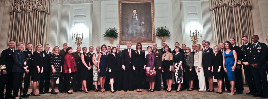 President Donald Trump and first lady Melania Trump, center, poses for a group photo with Senior Military leaders and spouses in the State Dining Room of the White House in Washington, Thursday, Oct. 5, 2017. Trump was hosting the dinner for the group this evening. (AP Photo/Pablo Martinez Monsivais)