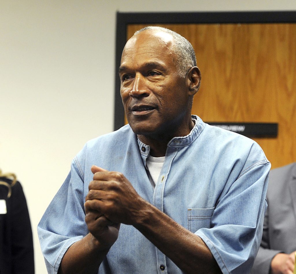 FILE - In this July 20, 2017 file photo, former NFL football star O.J. Simpson reacts after learning he was granted parole during a hearing at the Lovelock Correctional Center in Lovelock, Nev. Simpson was granted parole after more than eight years in prison for a Las Vegas hotel heist. A Nevada prison official said early Sunday, Oct. 1, 2017, O.J. Simpson, the former football legend and Hollywood star, has been released from a Nevada prison in Lovelock after serving nine years for armed robbery. (Jason Bean/The Reno Gazette-Journal via AP, Pool, File)