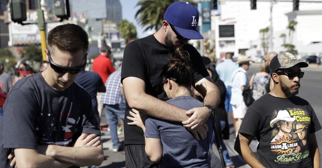 Reed Broschart, center, hugs his girlfriend Aria James on the Las Vegas Strip in the aftermath of a mass shooting at a concert Monday, Oct. 2, 2017, in Las Vegas. The couple, both of Ventura, Calif., attended the concert. (AP Photo/Marcio Jose Sanchez)