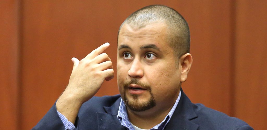 George Zimmerman describes his alleged injuries as he testifies during a hearing for accused shooter Matthew Apperson, Tuesday, Sept. 22, 2015, in Seminole circuit court in Sanford, Fla. Apperson is charged with attempted murder of Zimmerman for shooting into Zimmerman's vehicle in May, 2015. (Joe Burbank/Orlando Sentinel via AP, Pool)