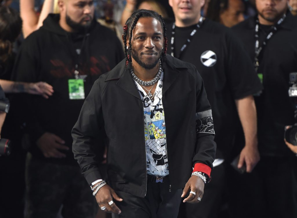 FILE - In this Aug. 27, 2017 file photo, Kendrick Lamar arrives at the MTV Video Music Awards at The Forum in Inglewood, Calif. Lamar and Olympic gymnast Aly Raisman are among the celebrities, athletes and business leaders heading to Boston for Forbes’ Under 30 Summit. The four-day event focused on technology and business starts Sunday, Oct. 1 and runs through Wednesday. (Photo by Chris Pizzello/Invision/AP, File)