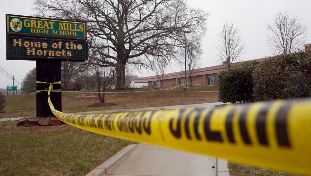 Crime scene tape is used around Great Mills High School, the scene of a shooting, Tuesday, March 20, 2018, in Great Mills. A student with a handgun shot two classmates inside the school before he was fatally wounded during a confrontation with a school resource officer, a sheriff said. (AP Photo/Alex Brandon)