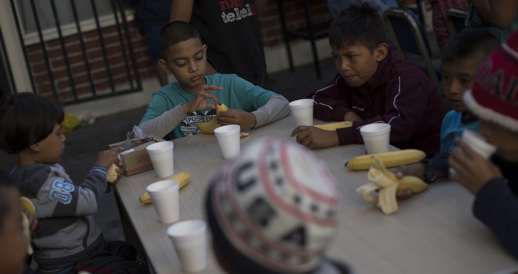 Children have their breakfast at the "Vina de Tijuana AC" migrant shelter in Tijuana, Mexico, Saturday, April 28, 2018. As the migrants prepare to walk to the "Casa del Tunel" to get legal advice from U.S. immigration lawyers, they are telling Central Americans in a caravan of asylum-seekers they may be separated from their children and detained for many months. (AP Photo/Hans-Maximo Musielik)