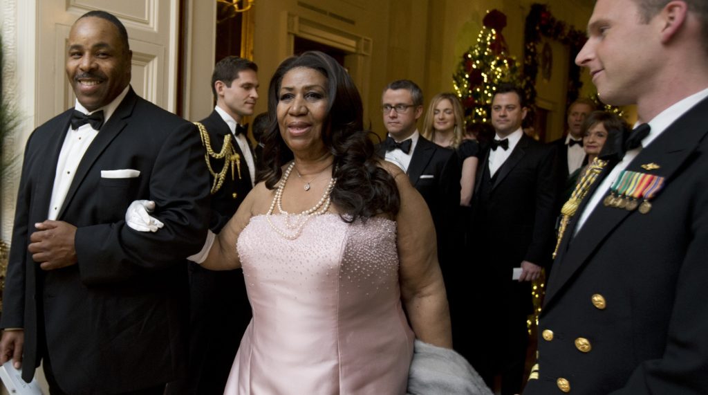 Singer Aretha Franklin, center, arrives at a reception hosted by President Barack Obama and first lady Michelle Obama in honor of the 2012 Kennedy Center Honors recipients, in the East Room of the White House in Washington, Sunday, Dec. 2, 2012. (AP Photo/Manuel Balce Ceneta)