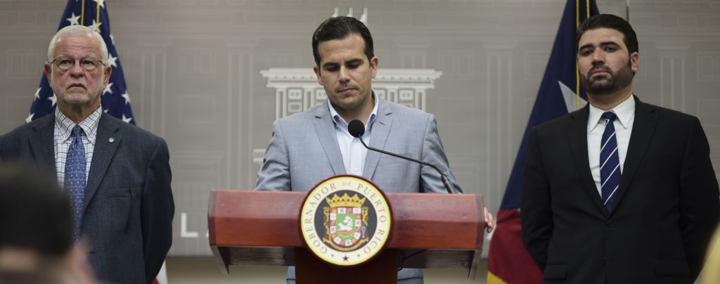Public Safety Secretary Hector Pesquera, from left, Executive Director of the Puerto Rico Federal Affairs Administration, PRFAA), Carlos Mercader and Puerto Rico Gov. Ricardo Rossello, attend a press conference regarding the number of estimated deaths in the aftermath of Hurricane Maria, in San Juan, Puerto Rico, Tuesday, Aug. 28, 2018. (AP Photo/Carlos Giusti)