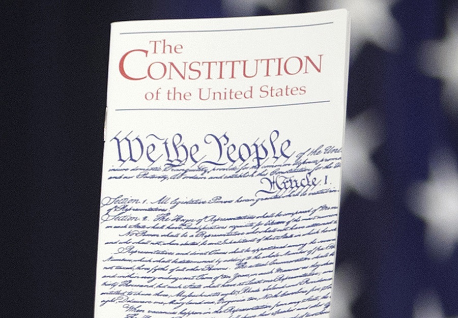 FILE - In this March 23, 2016 photo, the Constitution is held by a member of Congress on Capitol Hill in Washington. President Donald Trump says he wants to order the end of the constitutional right to citizenship for babies of non-citizens and unauthorized immigrants born in the United States. (AP Photo/J. Scott Applewhite)