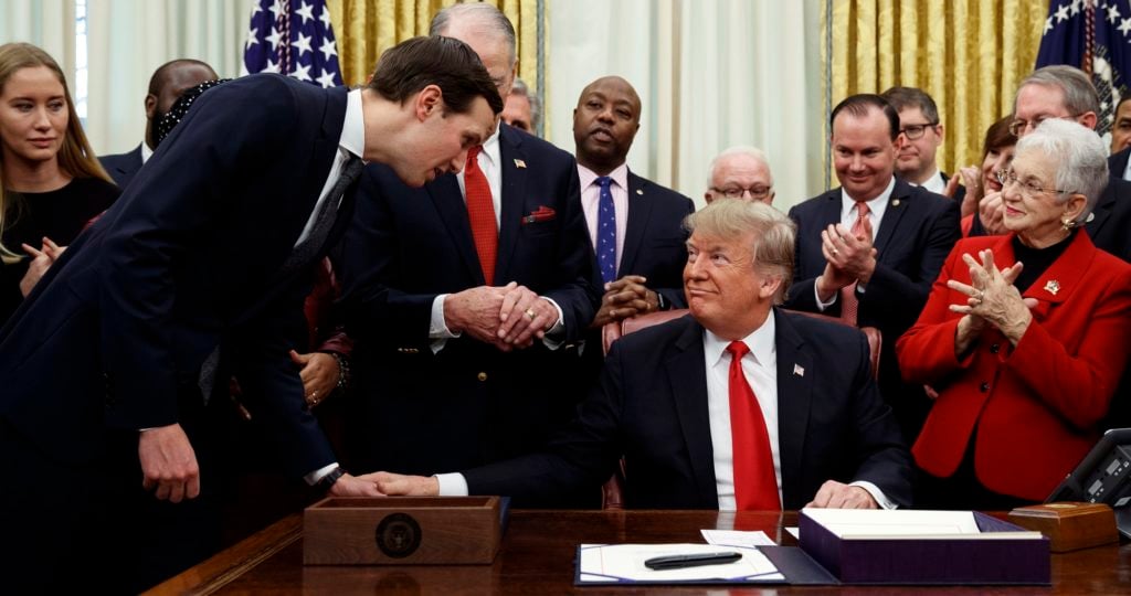White House senior adviser Jared Kushner talks with President Donald Trump during a signing ceremony for criminal justice reform legislation in the Oval Office of the White House, Friday, Dec. 21, 2018, in Washington. (AP Photo/Evan Vucci)