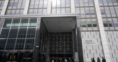 People enter the Phillip Burton Federal Building in San Francisco, where a lawsuit is challenging Trump’s federal job purge and Executive Order 14210.