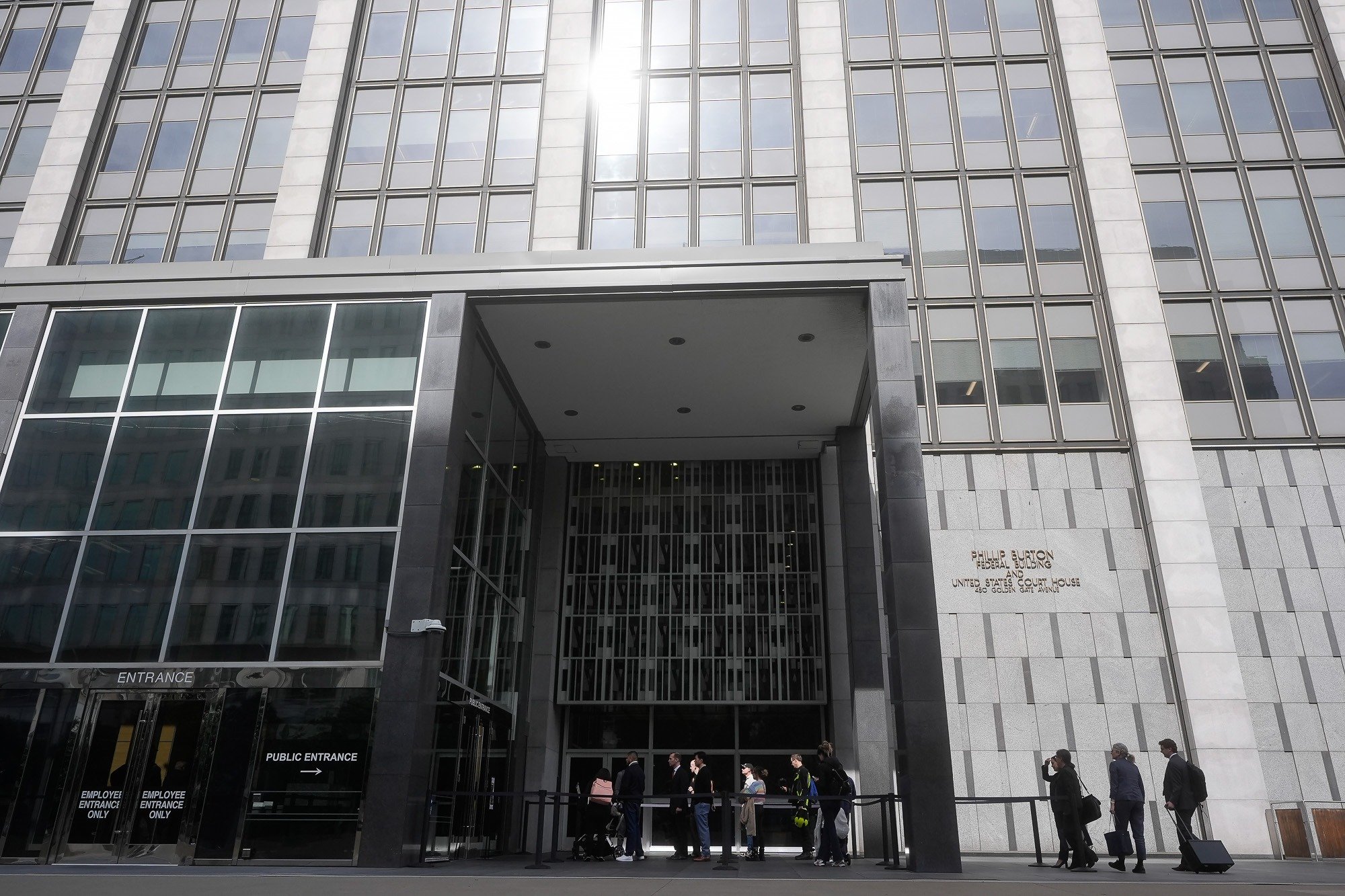 People enter the Phillip Burton Federal Building in San Francisco, where a lawsuit is challenging Trump’s federal job purge and Executive Order 14210.
