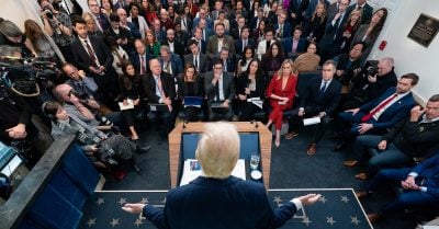 Donald Trump addresses a packed room of reporters at the White House amid growing economic turmoil during his second term