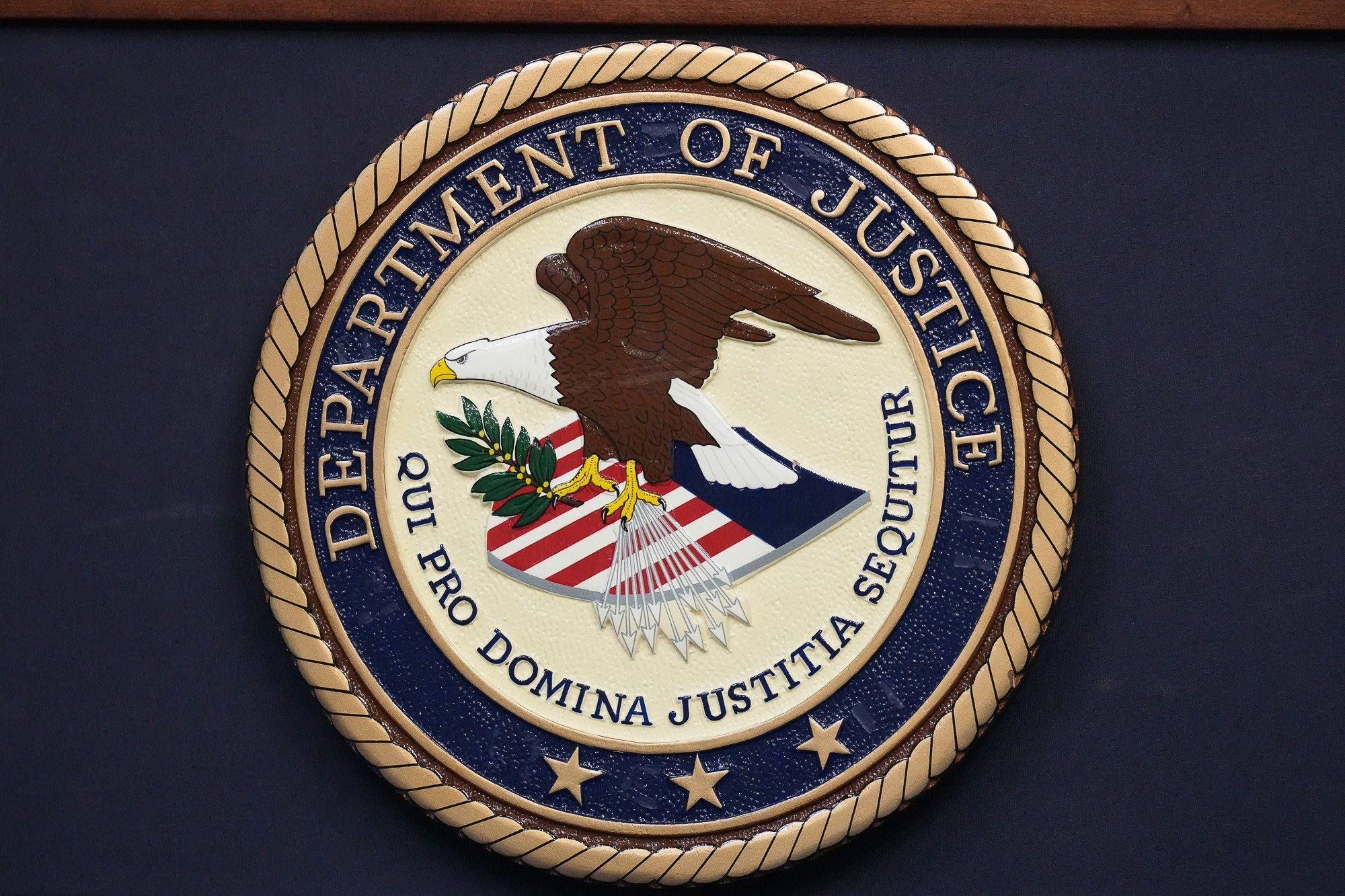 Department of Justice seal displayed on a wall as the agency’s Civil Rights Division faces mass resignations under Trump’s second term