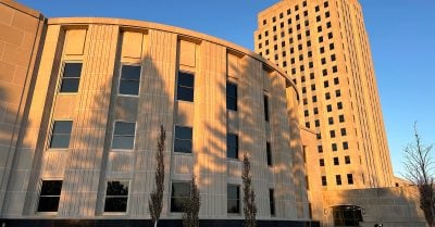 Sunlight illuminates the exterior of the North Dakota House of Representatives and the state Capitol tower in Bismarck, N.D.