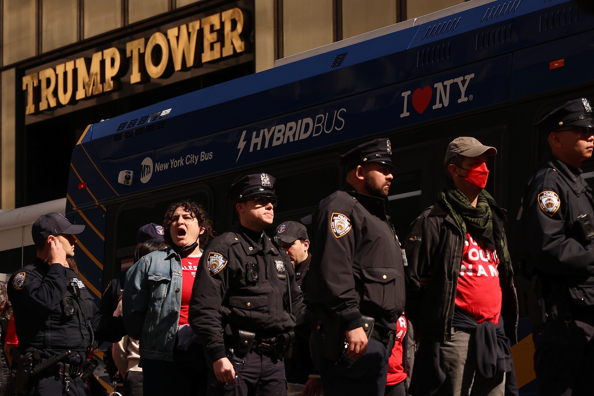 Protesters are detained by NYPD officers outside Trump Tower as concerns grow over Trump’s 2025 executive order on police militarization and federal support.
