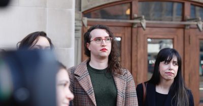 U.S. Army Sgt. 1st Class Sierra Moran, a transgender service member, listens during a press conference in Tacoma, Wash.