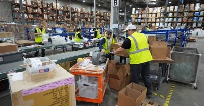 Trump economy faces racial disparities in jobs and wages as warehouse workers pack boxes in 2025.