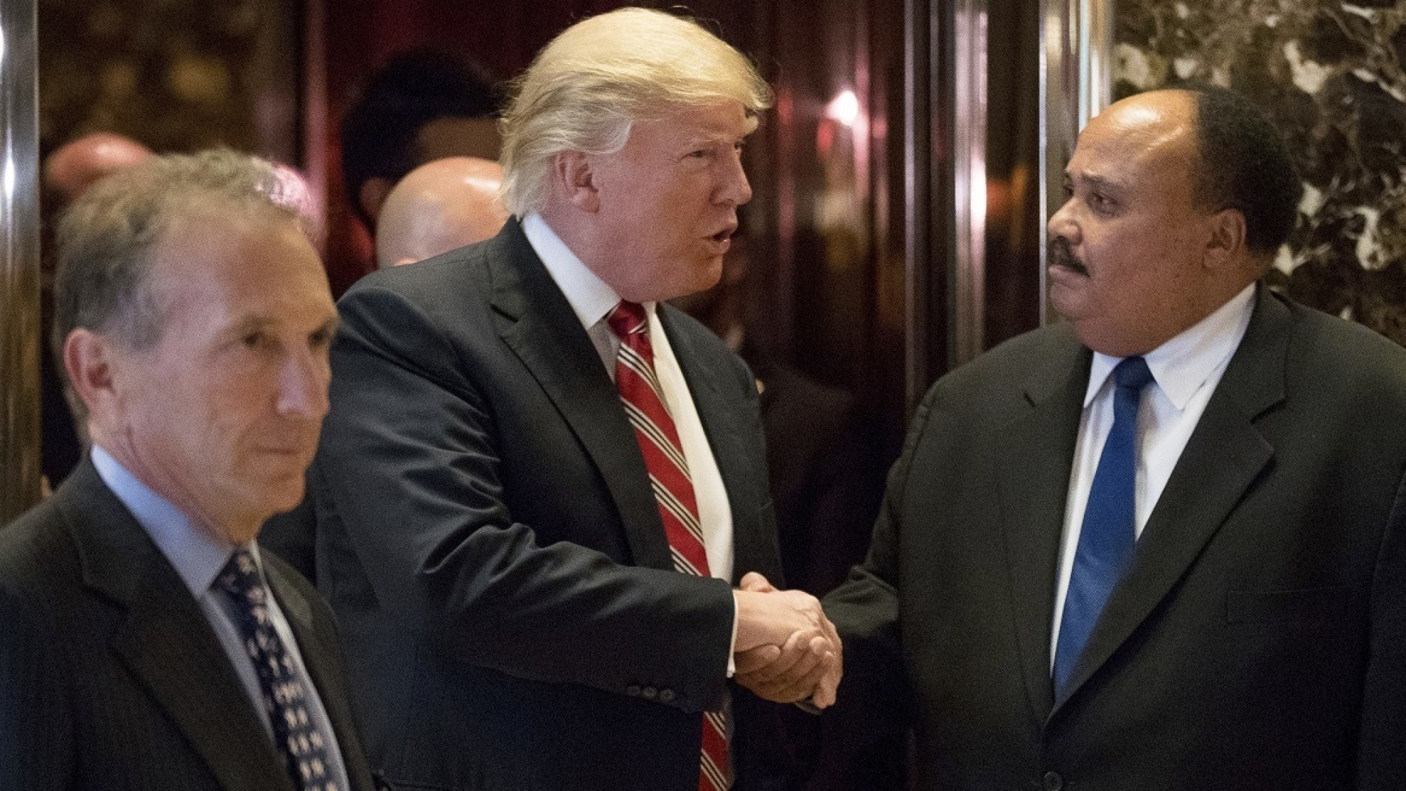 President-elect Donald Trump shakes hands with Martin Luther King III, son of Martin Luther King Jr. at Trump Tower in New York, Monday, Jan. 16, 2017. Also pictured is William Wachtel, left. (AP Photo/Andrew Harnik)
