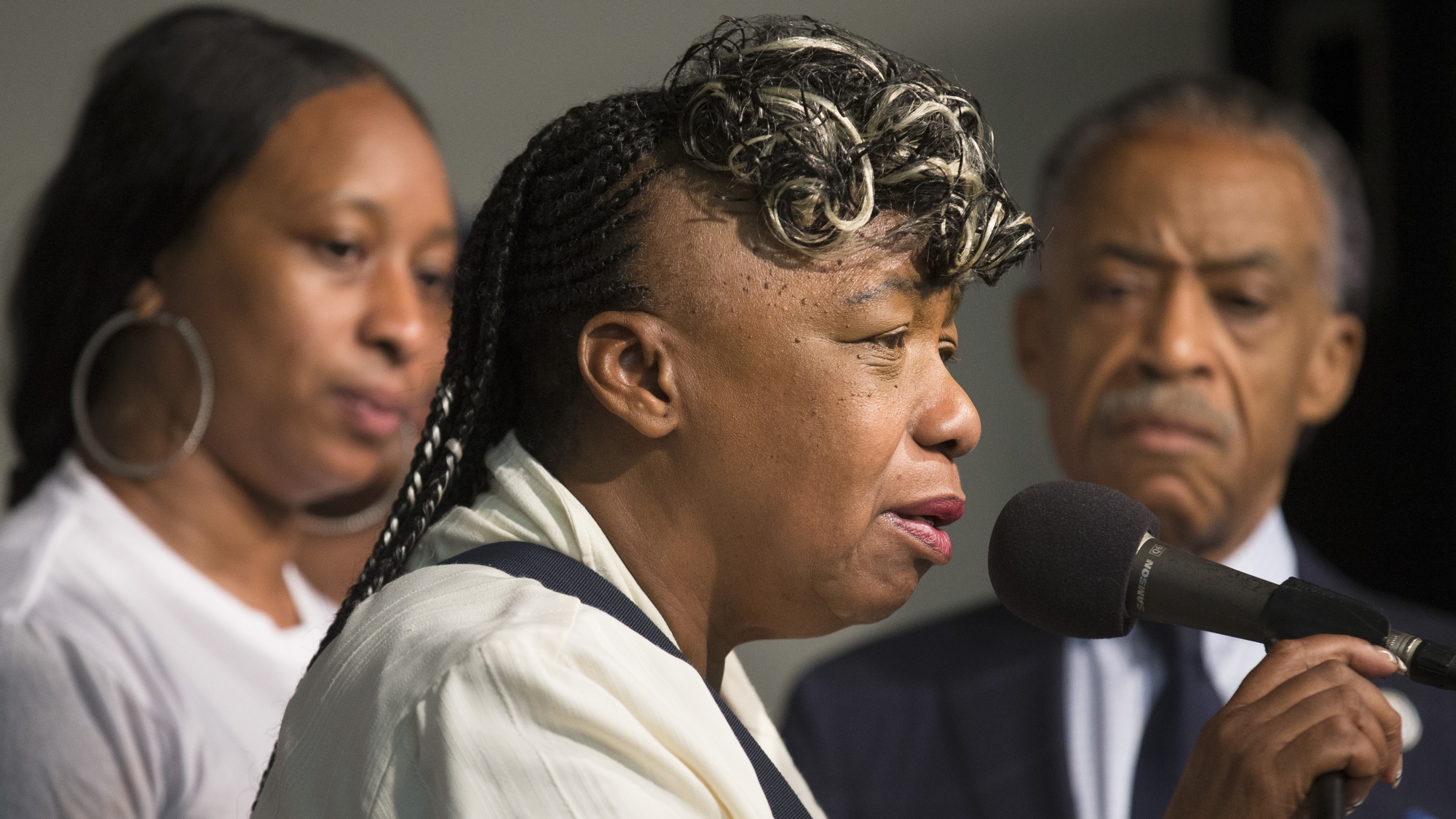 Gwen Carr, mother of Eric Garner, speaks alongside her daughter Ellisha Garner, left, and the Rev. Al Sharpton, right, during a rally at the National Action Network headquarters, Saturday, July 26, 2014, in New York. Eric Garner, 43, died on Thursday, July 18, during an arrest in Staten Island, when a plain-clothes police officer placed him in what appeared be a choke hold while several others brought him to the ground and struggled to place him in handcuffs. (AP Photo/John Minchillo)