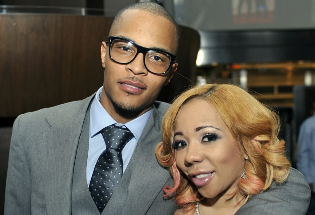 FILE - In this Oct. 3, 2010 file photo, Grammy award winning artist Clifford "TI" Harris, left, poses for media with his wife Tameka "Tiny" Harris, right, during an Alzheimers "For the Love of Our Fathers" foundation honoree luncheon at the Luckie Lounge in Atlanta. Police got unexpected help talking a suicidal man down from an Atlanta skyscraper when rapper T.I. showed up. Officer James Polite says the hip-hop star joined the crowd outside the 22-story building Wednesday and told officers he wanted to help. Police said the man agreed to come down in exchange for a few minutes face-to-face with T.I., whose real name is Clifford Harris. (AP Photo/Gregory Smith, File)