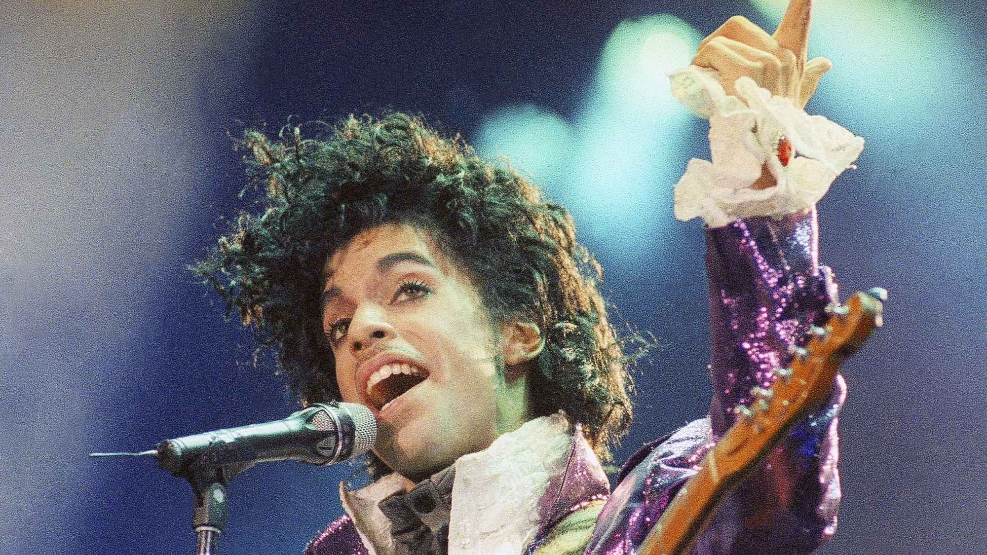 FILE - In this Feb. 18, 1985 file photo, Prince performs at the Forum in Inglewood, Calif. A year after Prince died of an accidental drug overdose, his Paisley Park studio complex and home is now a museum and concert venue. Fans can now stream most of his classic albums, and a remastered "Purple Rain" album is due out in June 2017 along with two albums of unreleased music and two concert films from his vault. (AP Photo/Liu Heung Shing, File)