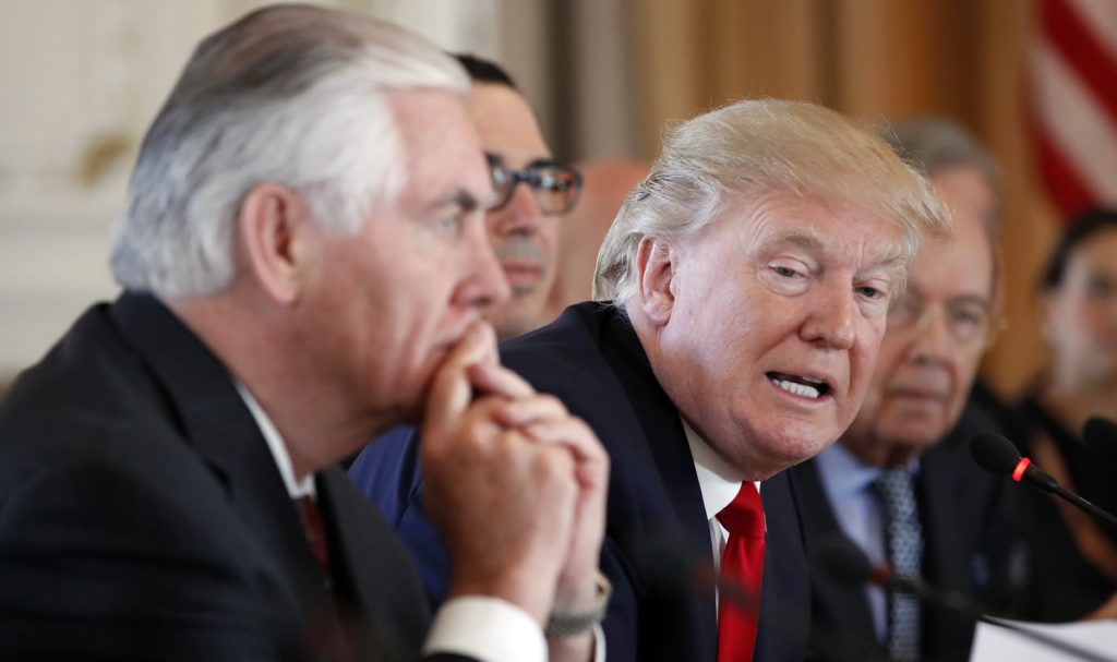 In this April 7, 2017, photo, President Donald Trump, joined by Secretary of State Rex Tillerson, left, speaks during a bilateral meeting with Chinese President Xi Jinping at Mar-a-Lago in Palm Beach, Fla. Lambasted for his low-key diplomacy, Tillerson is emerging from the shadows with his leading public role in shaping and explaining the Trump administration's missile strikes in Syria. He now takes on an even higher-profile mission, heading to Moscow this week under the twin clouds of Russia’s alleged U.S. election meddling and its possible support for a Syrian chemical weapons attack. (AP Photo/Alex Brandon)