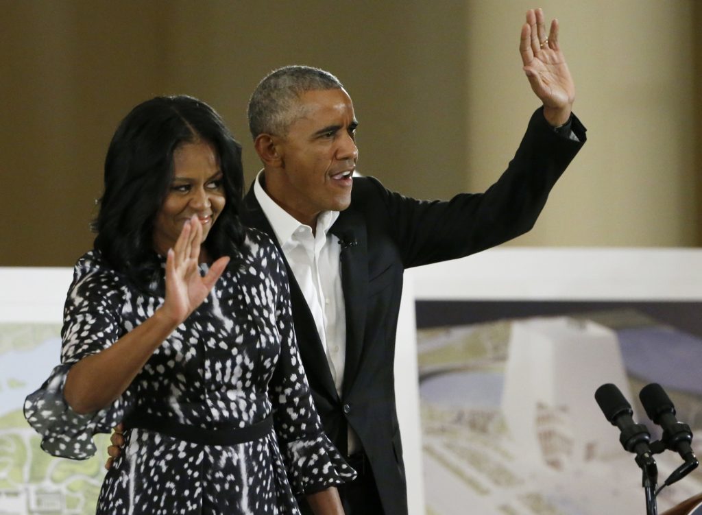 Former President Barack Obama and former first lady Michelle Obama waves as they arrive at a community event on the Presidential Center at the South Shore Cultural Center, Wednesday, May 3, 2017, in Chicago. The Obama Foundation unveiled plans for the former president's lakefront presidential center, showcasing renderings and a model at an event where former President Barack Obama and first lady Michelle Obama were expected to give more details. (AP Photo/Nam Y. Huh)