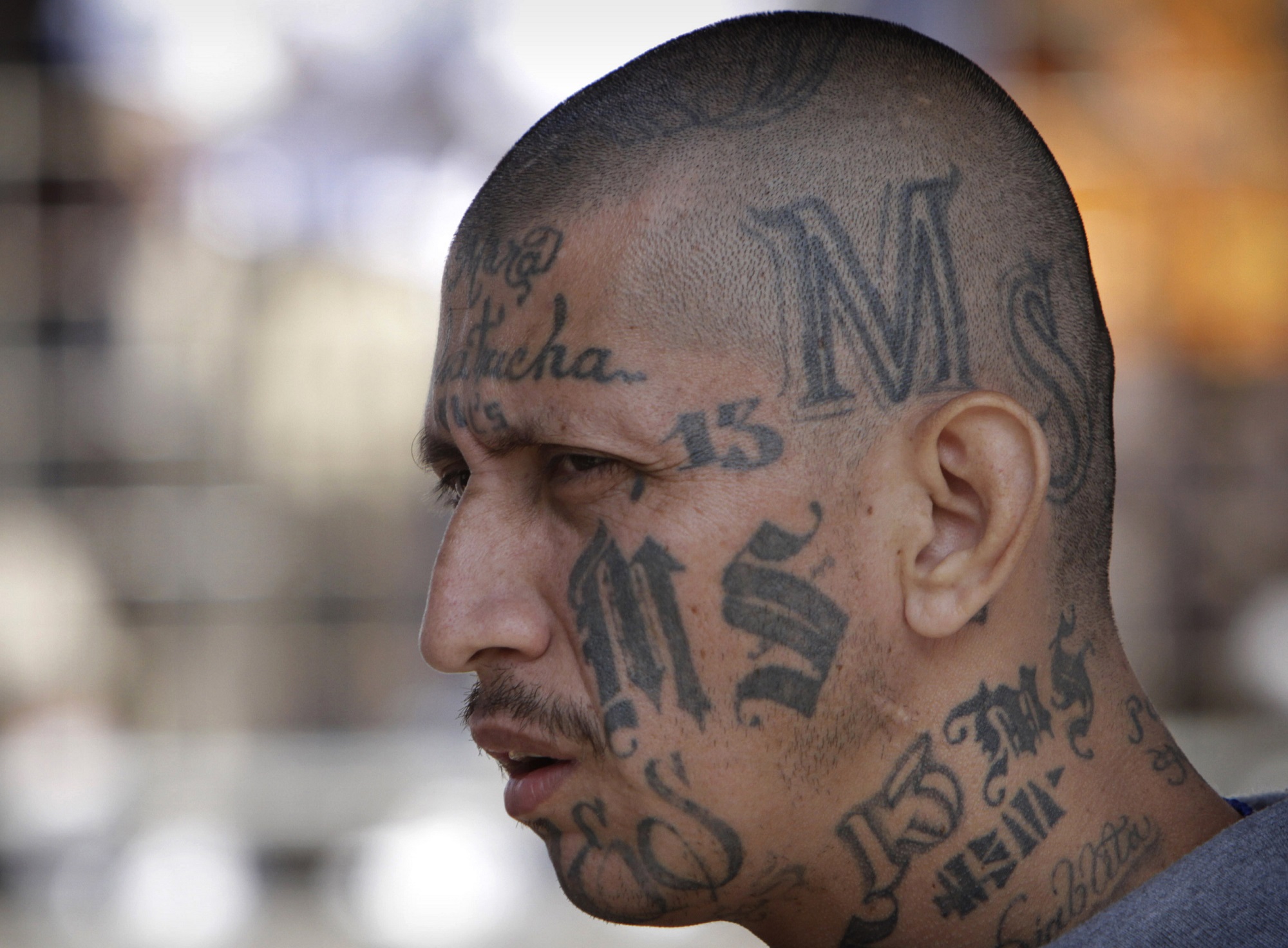 FILE - In this March 26, 2012 file photo a gang member of MS-13 attends mas...
