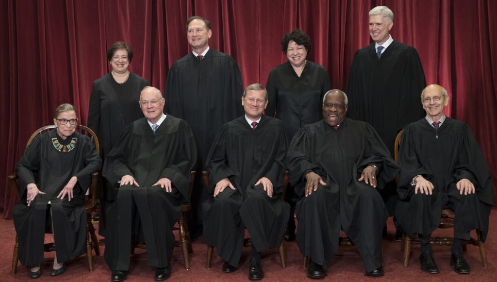 The justices of the U.S. Supreme Court gather for an official group portrait to include new Associate Justice Neil Gorsuch, top row, far right, Thursday. June 1, 2017, at the Supreme Court Building in Washington. Seated, front row, from left are, Associate Justice Ruth Bader Ginsburg, Associate Justice Anthony M. Kennedy, Chief Justice of the United States John Roberts, Associate Justice Clarence Thomas, and Associate Justice Stephen Breyer. Back row, standing, from left are, Associate Justice Elena Kagan, Associate Justice Samuel Alito Jr., Associate Justice Sonia Sotomayor, and Associate Justice Neil Gorsuch. (AP Photo/J. Scott Applewhite)