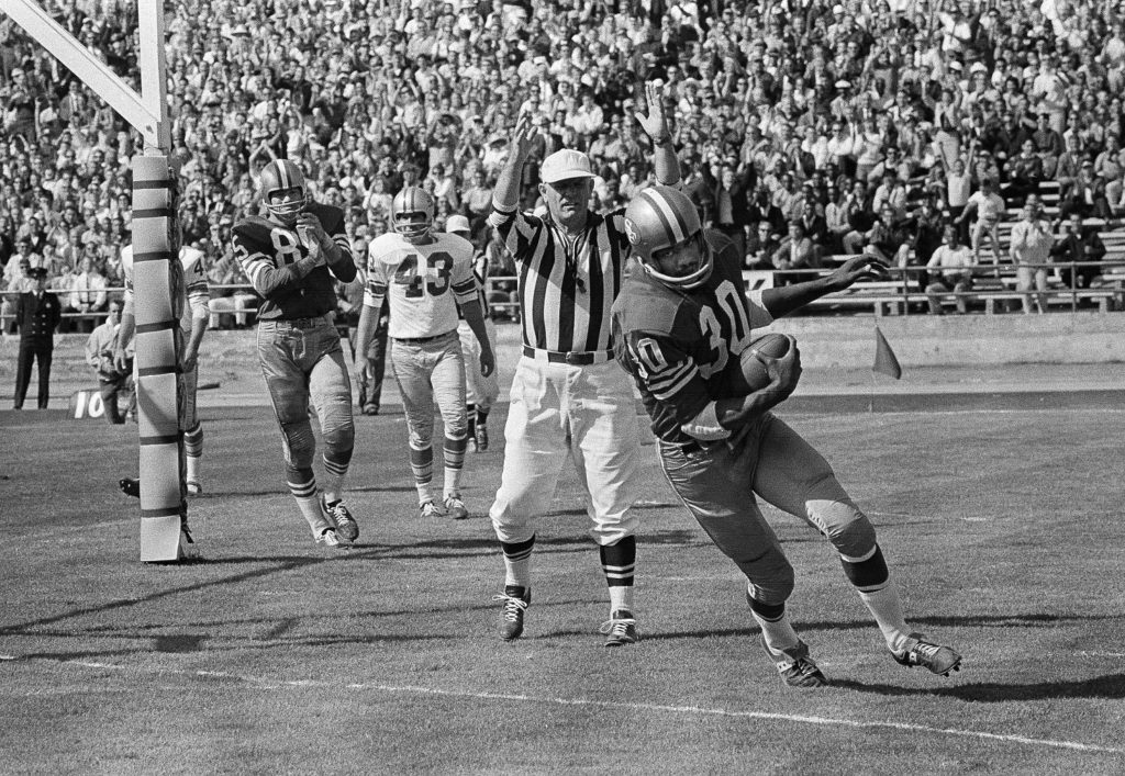 San Francisco 49er Bernie Casey (30) catches pass from quarterback John Brodie at left, and scoots over the goal line for 49er third period touchdown on Sept. 13, 1964 at Kezar Stadium in San Francisco in game with Detroit Lions. Lions defensive back Bobby Thompson (27) tries to bring him down. Detroit won, 26-17. (AP Photo)
