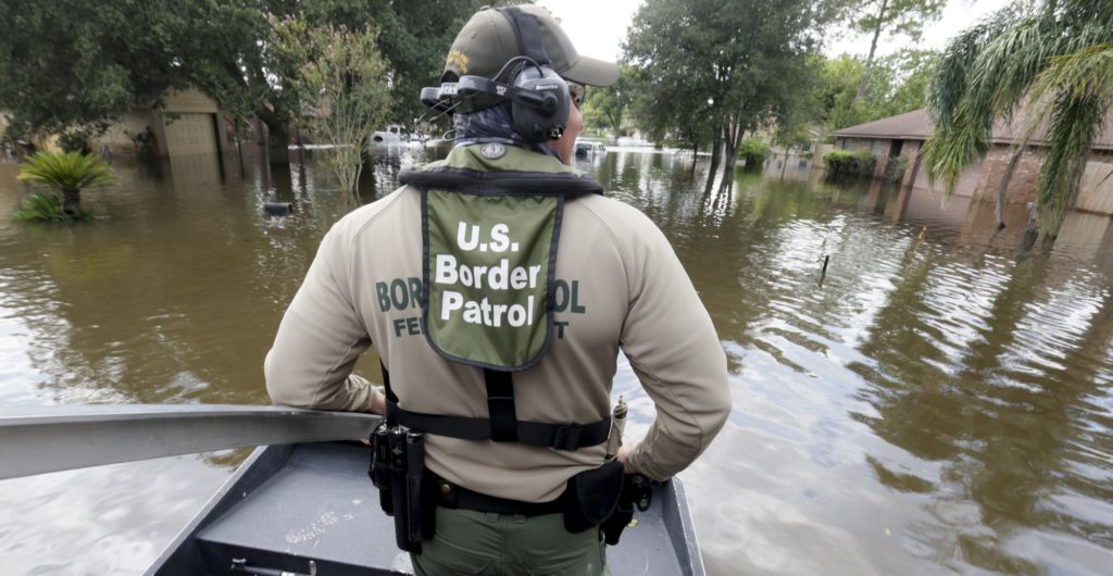 U.S. Border Patrol Agent Steven Blackburn looks out while standing on the bow of an air boat during a search a rescue operation in a neighborhood inundated by floodwaters from Tropical Storm Harvey in Houston, Texas, Wednesday, Aug. 30, 2017. (AP Photo/LM Otero)