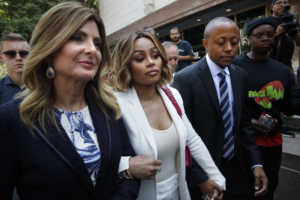 Blac Chyna, center, is flanked by her attorneys, Lisa Bloom, left, and Walter Mosley, as she leaves a courthouse after a hearing on Monday, July 10, 2017, in Los Angeles. A court commissioner has granted Chyna a temporary restraining order against her former fiancee, reality television star Rob Kardashian. (AP Photo/Jae C. Hong)