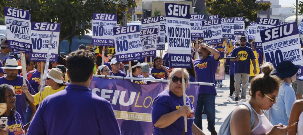 Service Employees International Union, SEIU, gather for a Labor Day rally in downtown Los Angeles on Monday, Sept. 4, 2017. (AP Photo/Richard Vogel)