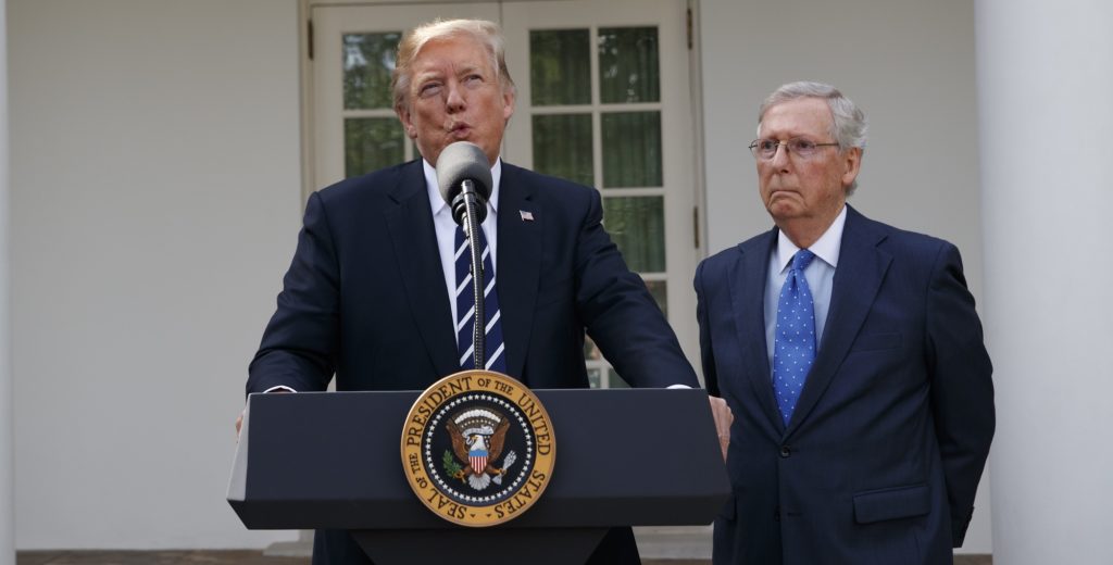 Senate Majority Leader Mitch McConnell, R-Ky., listens as President Donald Trump speaks with reporters in the Rose Garden of the White House, Monday, Oct. 16, 2017, in Washington. (AP Photo/Evan Vucci)
