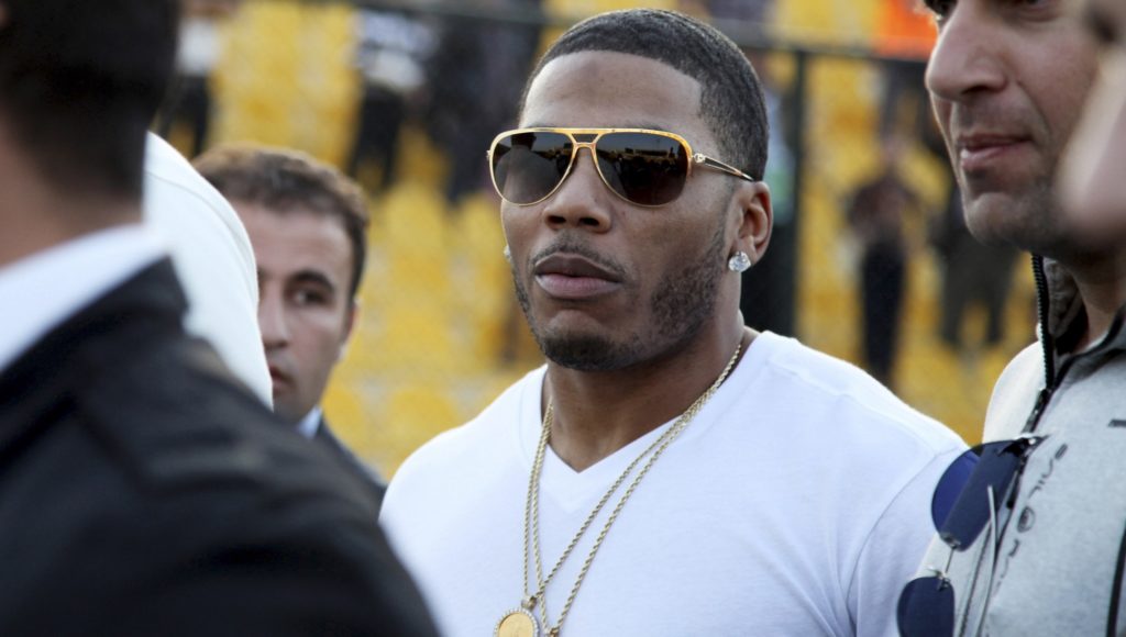 FILE- In March 13, 2015, file photo, rapper Nelly approaches the stage for a concert in Irbil, northern Iraq. Police have arrested Nelly after a woman said he raped her in a town outside Seattle, an accusation the Grammy winner's attorney staunchly denies. Auburn police spokesman Commander Steve Stocker said officers arrested Nelly early Saturday, Oct. 7, 2017, morning in his tour bus at a Walmart.  (AP Photo/Seivan M. Salim, File)