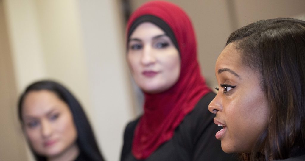 Tamika Mallory, right, co-chair of the Women's March on Washington, talks during an interview Jan. 9, 2017 with fellow co-chairs Carmen Perez, left, and Linda Sarsour, in New York. The march will be held Jan. 21, 2017, the day after Donald Trump's inauguration. (AP Photo/Mark Lennihan)