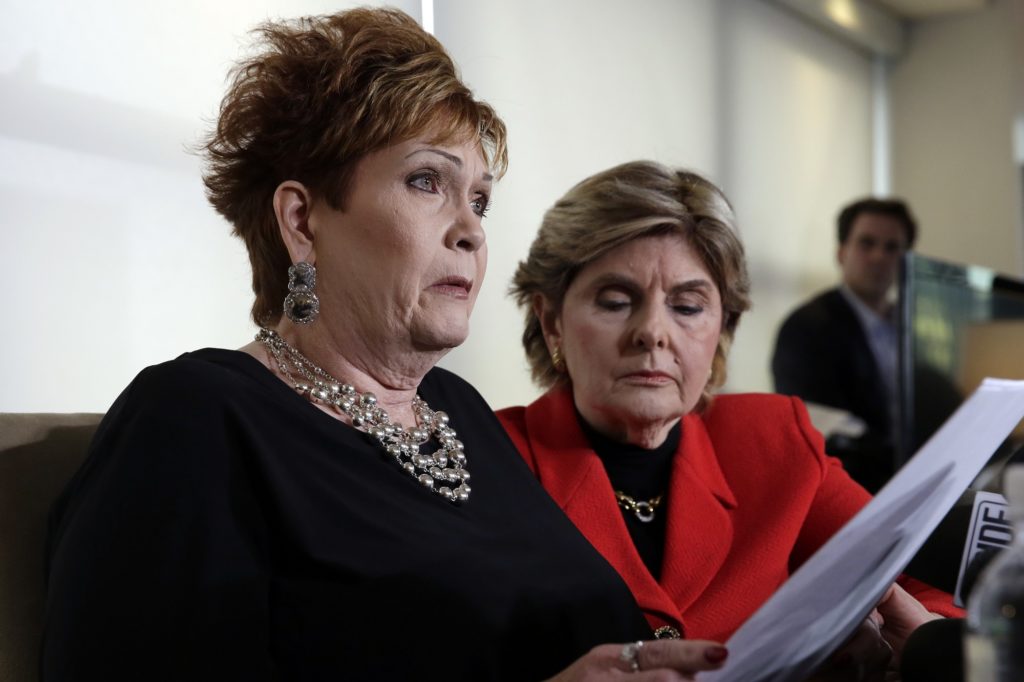 Beverly Young Nelson, left, the latest accuser of Alabama Republican Roy Moore, reads her statement as attorney Gloria Allred looks on, at a news conference, in New York, Monday, Nov. 13, 2017. Nelson says Moore assaulted her when she was 16 and he offered her a ride home from a restaurant where she worked. Moore says the latest allegations against him are a "witch hunt." (AP Photo/Richard Drew)