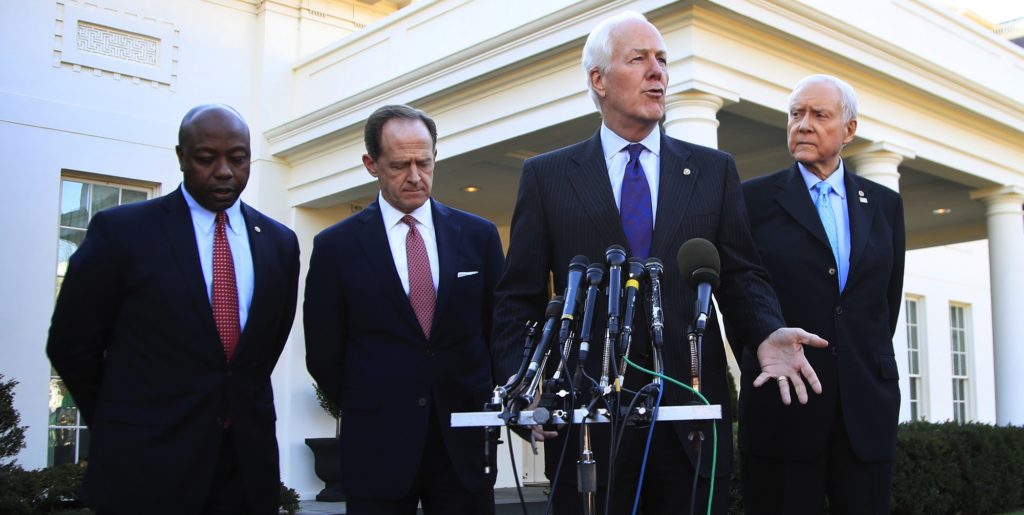Senate Finance Committee member Sen. John Cornyn, R-Texas, second from right, with, from left, Sens. Tim Scott, R-S.C., Patrick Toomey, R-Pa., and Chairman Orrin Hatch, R-Utah, speaks to reporters following a meeting with President Donald Trump at the White House in Washington, Monday, Nov. 27, 2017. (AP Photo/Manuel Balce Ceneta)