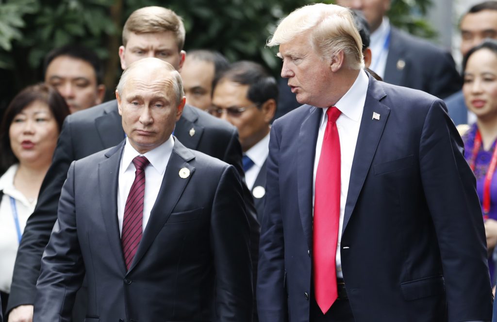 U.S. President Donald Trump, right, and Russia's President Vladimir Putin talk during the family photo session at the APEC Summit in Danang, Vietnam Saturday, Nov. 11, 2017. Trump and Putin may not be having a formal meeting while they’re in Vietnam for an economic summit. But the two appear to be chumming it up nonetheless. Snippets of video from the Asia-Pacific Economic Cooperation conference Saturday have shown the leaders chatting and shaking hands at events including a world leaders’ group photo. (Jorge Silva/Pool Photo via AP)