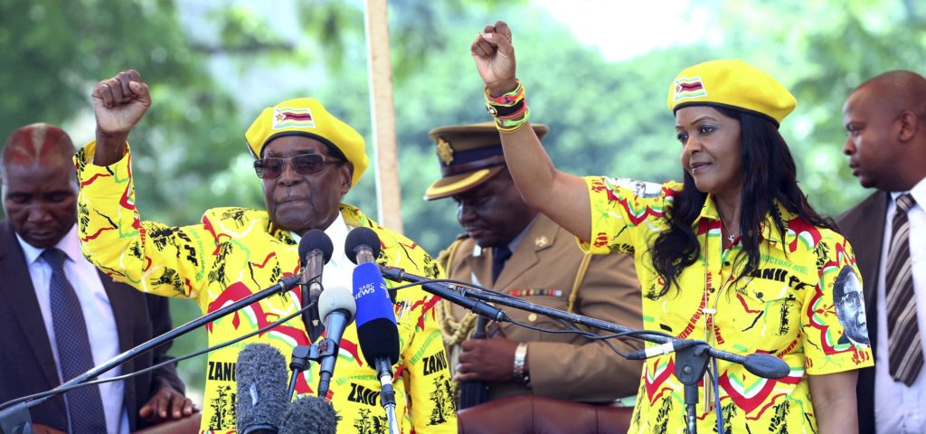FILE - In this Nov. 8, 2017, file photo, Zimbabwe's President Robert Mugabe, left, and his wife Grace Mugabe chant the party's slogan during a solidarity rally in Harare, Zimbabwe. Zimbabwe's army said Wednesday, Nov. 15, 2017, it has Mugabe and his wife in custody and is securing government offices and patrolling the capital's streets following a night of unrest that included a military takeover of the state broadcaster. (AP Photo/File)