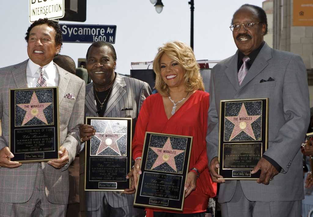 Members of The Miracles are honored with a star on the Hollywood Walk of Fame in Los Angeles on Friday, March 20, 2009. From left: William "Smokey" Robinson, Warren "Pete" Moore, Claudette Robinson, and Robert "Bobby" Roberts. (AP Photo/Damian Dovarganes)
