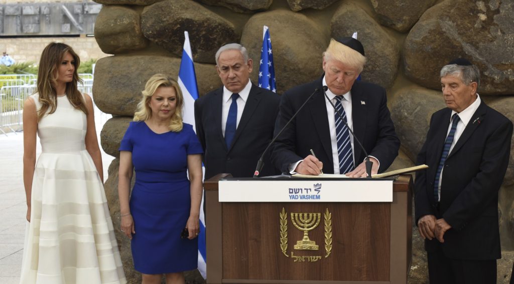 U.S. President Donald Trump signs the guest book at the Yad Vashem Holocaust Memorial museum, commemorating the six million Jews killed by the Nazis during World War II, on Tuesday, May 23, 2017, in Jerusalem. ( Gali Tibbon, Pool via AP)