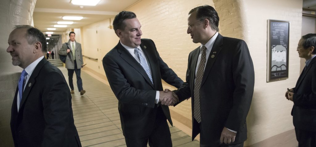 Rep. Richard Hudson, R-N.C., center left, greets Rep. Dave Brat R-Va., center right, as House Republicans arrive for a closed-door strategy session as the deadline looms to pass a spending bill to fund the government by week's end, on Capitol Hill in Washington, Tuesday, Dec. 5, 2017. (AP Photo/J. Scott Applewhite)