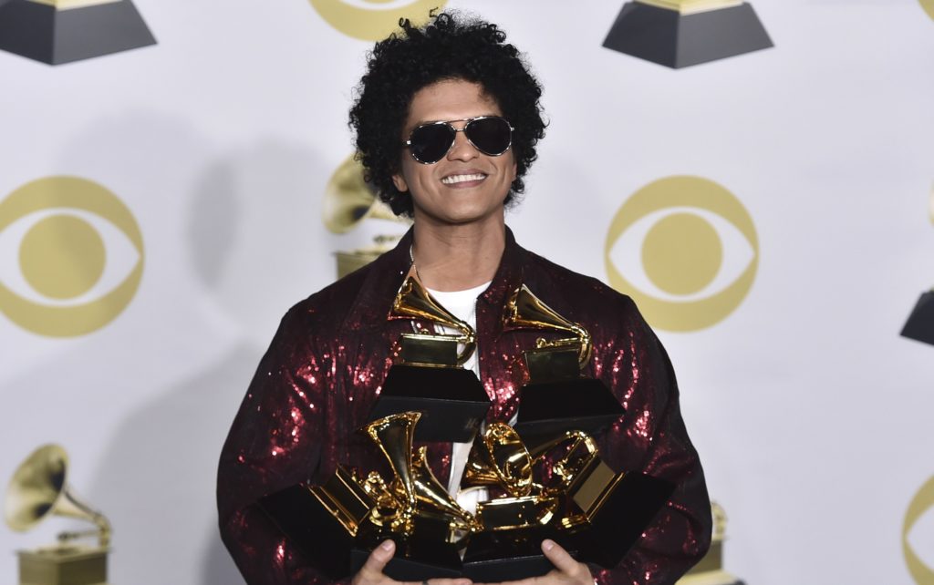 Bruno Mars poses in the press room with his awards for best R&B album, record of the year, album of the year, best engineered album, non-classical, for "24K Magic," and song of the year, best R&B performance and best R&B song, for "That's What I Like" at the 60th annual Grammy Awards at Madison Square Garden on Sunday, Jan. 28, 2018, in New York. (Photo by Charles Sykes/Invision/AP)