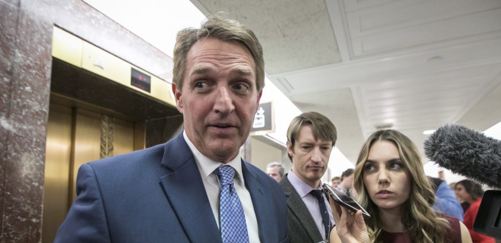 Sen. Jeff Flake, R-Ariz., speaks to reporters as he leaves the office of Sen. Susan Collins, R-Maine, who is moderating bipartisan negotiations on immigration, at the Capitol in Washington, Thursday, Jan. 25, 2018. President Donald Trump has given Congress until March to come up with a plan to protect the nearly 700,000 young people who had been protected from deportation and given the right to work legally in the country under the Obama-era Deferred Action for Childhood Arrivals program, or DACA. Trump announced he was ending DACA last year. (AP Photo/J. Scott Applewhite)