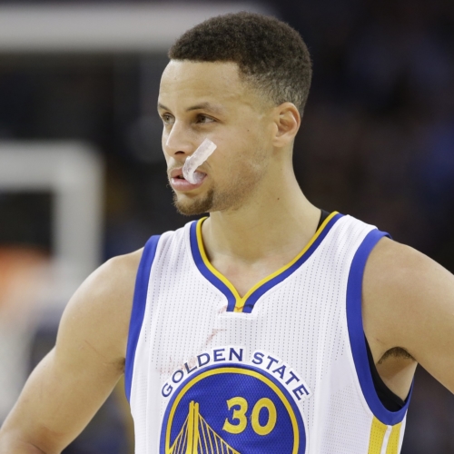 In this Friday, April 1, 2016 photo, Golden State Warriors' Steph Curry (30) pauses during an NBA basketball game against the Boston Celtics in Oakland, Calif. Though he moved on to the NBA long ago, March Madness is also Curry's world now. (AP Photo/Marcio Jose Sanchez)