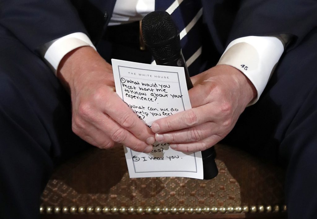 President Donald Trump holds notes during a listening session with high school students and teachers in the State Dining Room of the White House in Washington, Wednesday, Feb. 21, 2018. Trump heard the stories of students and parents affected by school shootings, following last week's deadly shooting in Florida. (AP Photo/Carolyn Kaster)