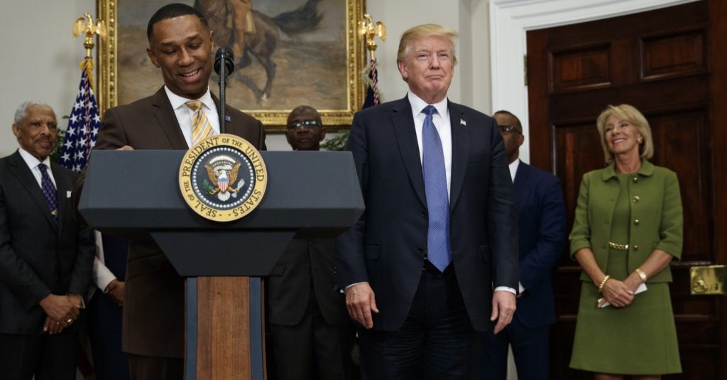 Johnny C. Taylor Jr., left, pauses as he speaks as President Donald Trump and Education Secretary Betsy DeVos, stand right, during an event in the Roosevelt Room of the White House in Washington, Tuesday, Feb. 27, 2018, to announce Taylor as chairman of in the president's board of advisors on Historically Black Colleges and Universities (HBCU.) (AP Photo/Carolyn Kaster)