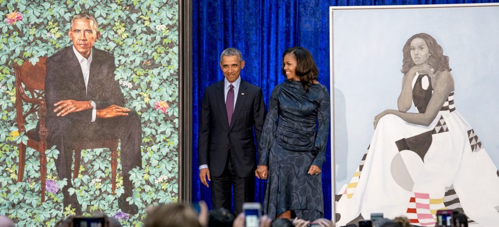 Former President Barack Obama and former first lady Michelle Obama stand on stage as their official portraits are unveiled at a ceremony at the Smithsonian's National Portrait Gallery, Monday, Feb. 12, 2018, in Washington. Barack Obama's portrait was painted by artist Kehinde Wiley, and Michelle Obama's portrait was painted by artist Amy Sherald. (AP Photo/Andrew Harnik)